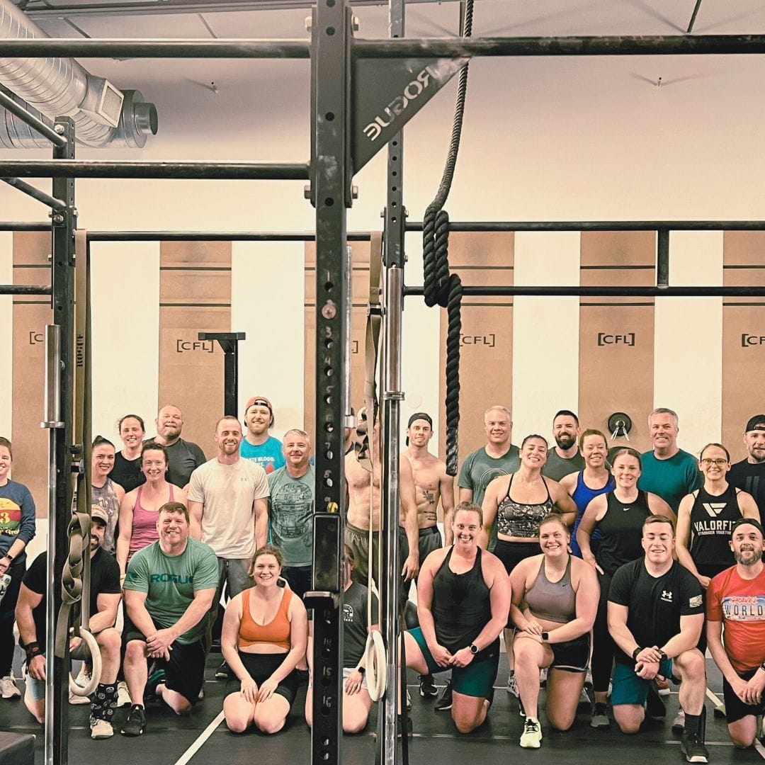 group of people in crossfit gym after training